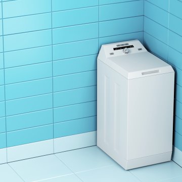 top load washing machine in corner blue walls
